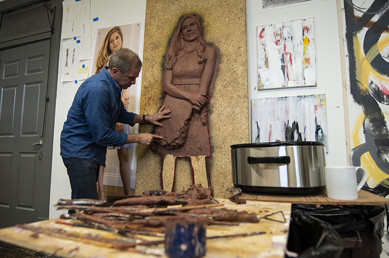 Tom Corbin sculpts a bas-relief in his studio, a converted firehouse in Rosedale, Kansas.