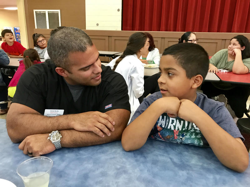 UIW medical student Edwin Davila talks to a Southside ISD student at a family orientation in the fall of 2017.