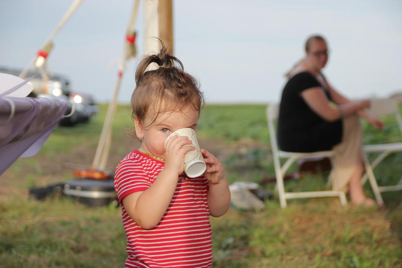 Juniper Lane sips sweet tea at the second annual Organic Fest hosted by the Illinois Organic Growers Association. (KUNC/Abby Wendle)