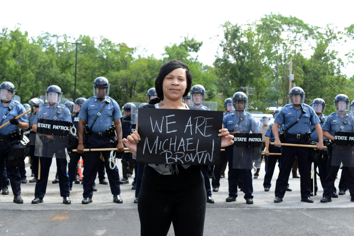 Arianna Whiteside holding a 'We are Michael Brown' sign