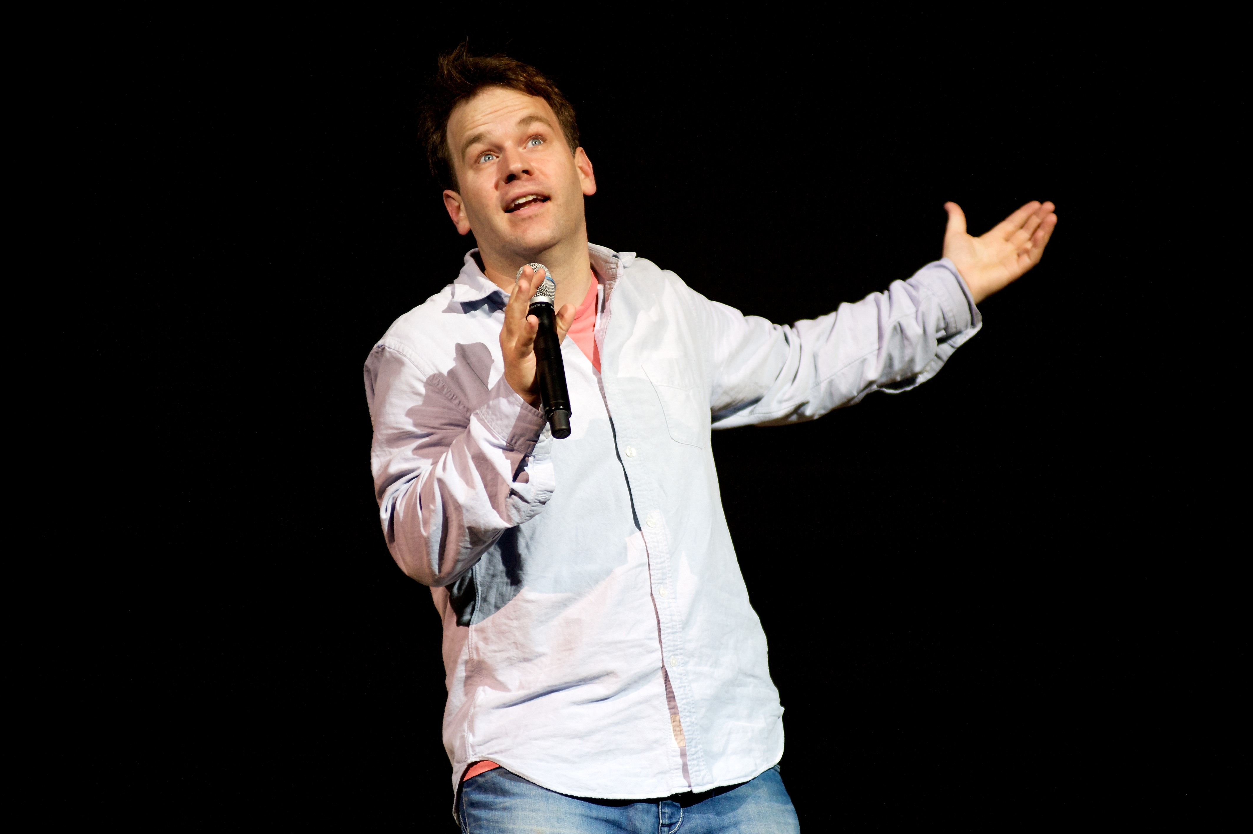 Mike Birbiglia Performing In Jeans and A Button Down Shirt