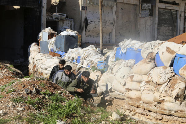 Free Syrian Army fighters run behind sandbags in Daraa Al-Mahata, in southern Syria, on Jan. 21. Many moderate rebels joined the uprising to fight against President Bashar Assad, but the U.S. plans to train them to fight the self-proclaimed Islamic State.