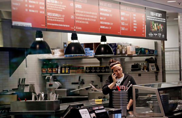 <p>A woman talks on the phone as she stands in the kitchen area of a closed Chipotle restaurant, Monday, Nov. 2, 2015, in Seattle. An E. coli outbreak linked to Chipotle restaurants in Washington state and Oregon has sickened several dozen people in the third outbreak of foodborne illness at the popular chain this year.</p>