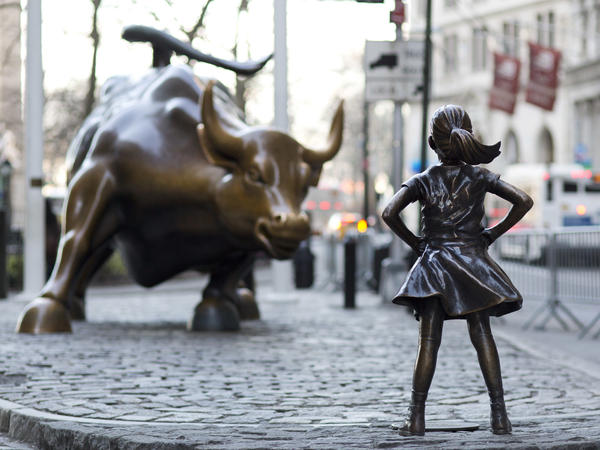 The <em>Charging Bull</em> and <em>Fearless Girl</em> square off in New York City's financial district. Arturo Di Modica, the bull's sculptor, says the girl staring it down has changed the meaning of his work in an unwelcome way.