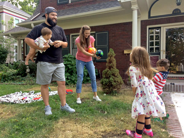 Entrepreneur Stinson Dean (left) and his wife Stephanie play with their three children in their yard in Independence, Mo. He says the Affordable Care Act made it possible for him to start his own business.