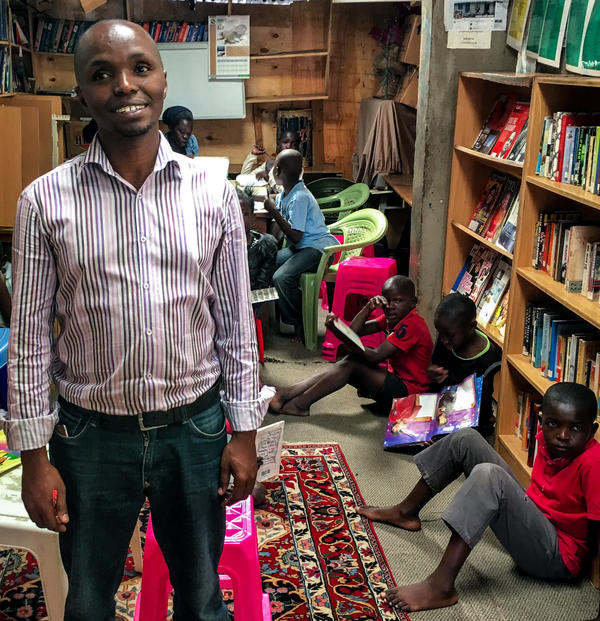 Douglas Ng'ang'a in his home, which he has converted into a community library.