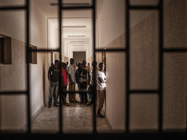 Detainees stand in a hall at a detention center for migrants in Al Kararim, Libya. The North African country is a key transit spot and destination for migrants seeking employment or a path to Europe.