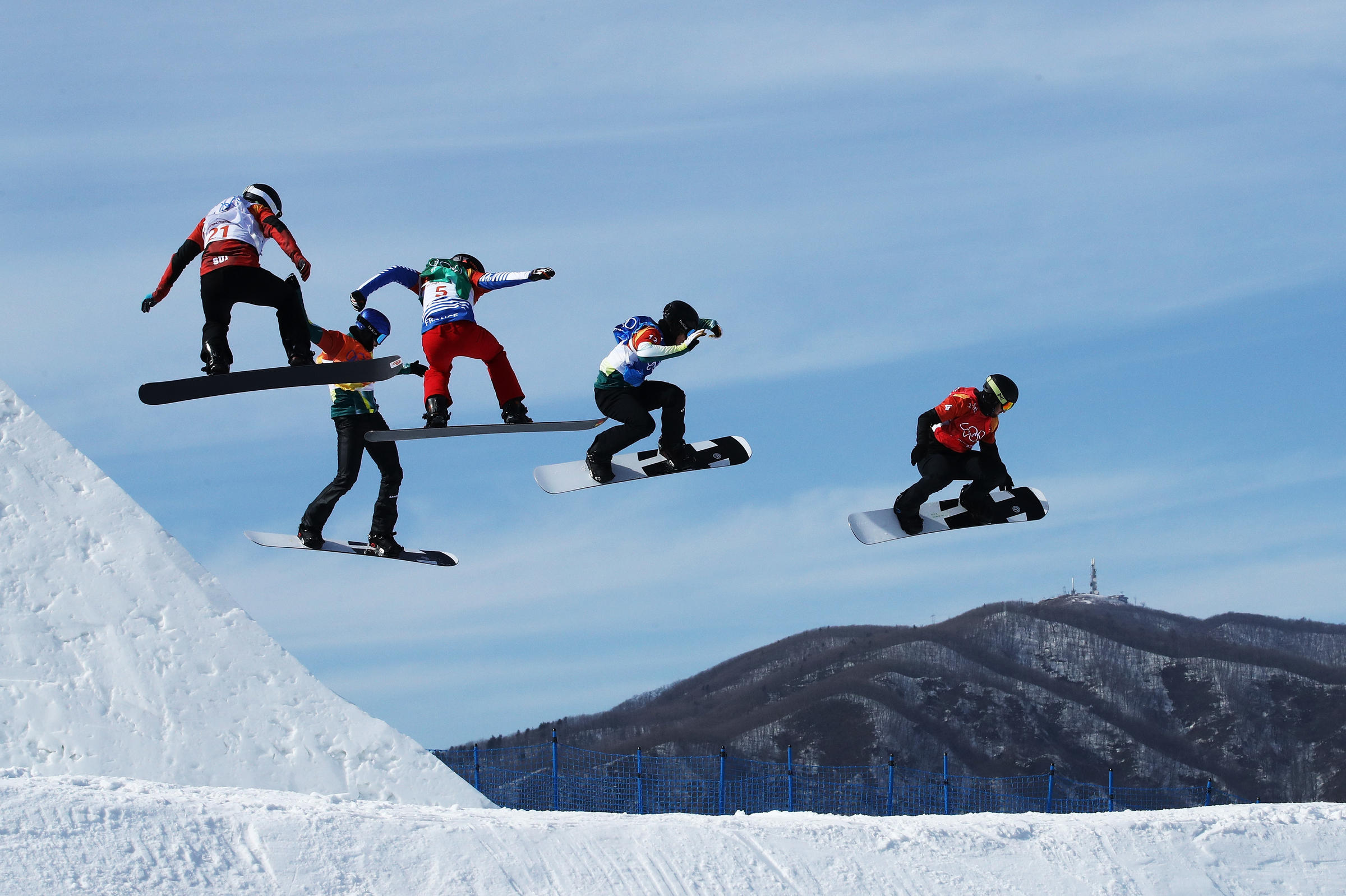 men compete during the snowboard cross quarterfinals on thursday