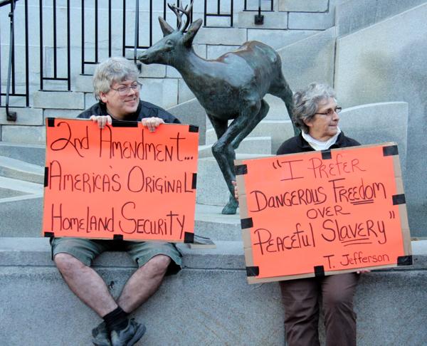 Bob Dougall of Bolton, left, and Diane Tardif of Essex Junction came to Burlington Monday to protest proposed gun control measures.