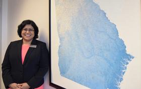 Dr. Seema Csukas in front of a map of Georgia