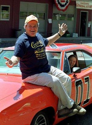 Cooter, actor Ben Jones, sits atop one of the 229 hotrods, named the General Lee, used in the show "Dukes of Hazzard" as ecstatic fan, Aliceson Johnson, of Charlottesville, Va., sits in the drivers seat in front of his store in Sperryville, Va., Tuesday, 