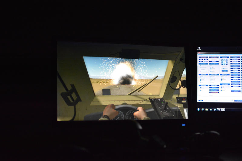 In the BRAVEMIND system, researchers can dim lights or reproduce explosions and rocket fire. This scene is from inside a military humvee.
