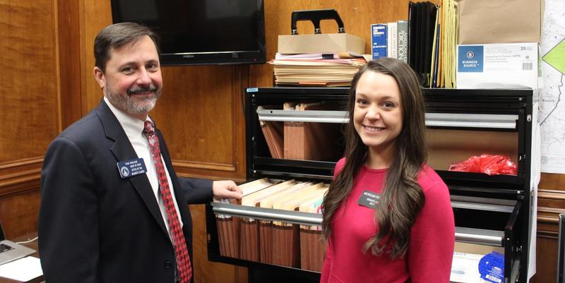 Tom Krause and Morgan Penland stand by the cabinet where they file messages that come into Georgia senate Republican Majority Leader Bill Cowsert's office.