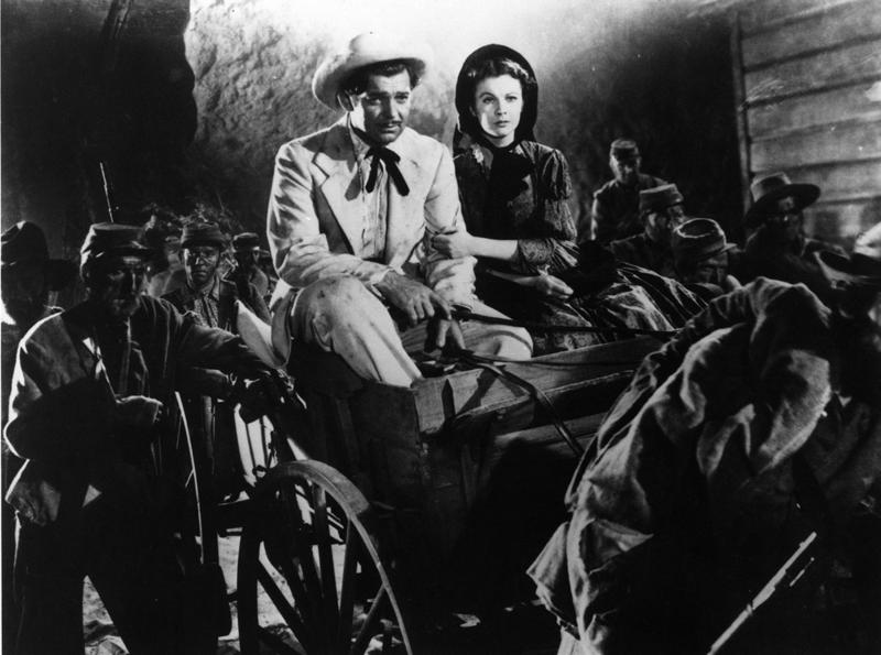 Rhett Butler (Clark Grable) and Scarlett O'Hara (Vivien Leigh) get a first-hand look at the Civil War as they drive a wagon through a column of retreating toops in the 1939 movie "Gone with the winds" a feature presentation on NBC 11/76.