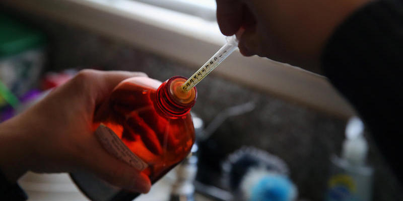 Aileen Burger loads an oral syringe with cannabis-infused oil used as medicine for her 4-year-old daughter Elizabeth, who suffers from severe epilepsy.