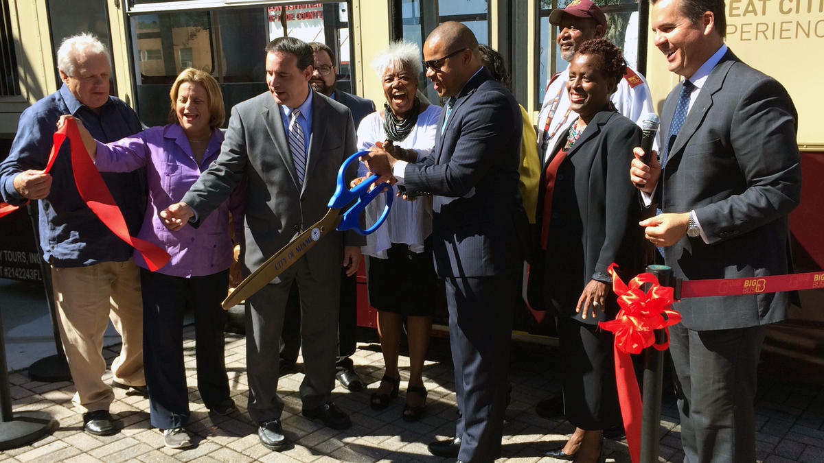 Community leaders, members of GMCVB, and staff of Big Bus Miami cutting the ribbon that launched the new tour route, Uptown Loop, on Thursday, Oct. 16, at the Lyric Theater in Overtown.