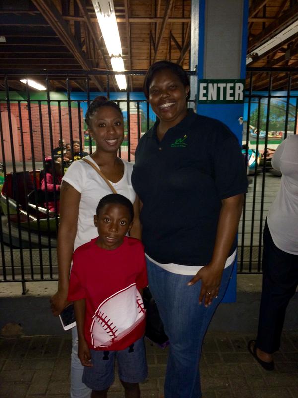 Wilson parents Dana Wade and Miesha Jackson pose in front of the bumper cars at InspireNOLA Family Night. They want to make sure Wilson's new operator won't treat the school, or the students, like failures.