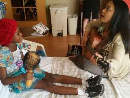 Miracle Millionor and her music therapist, Rich Moats, sing recentlty at Florida Hospital for Children in Orlando.