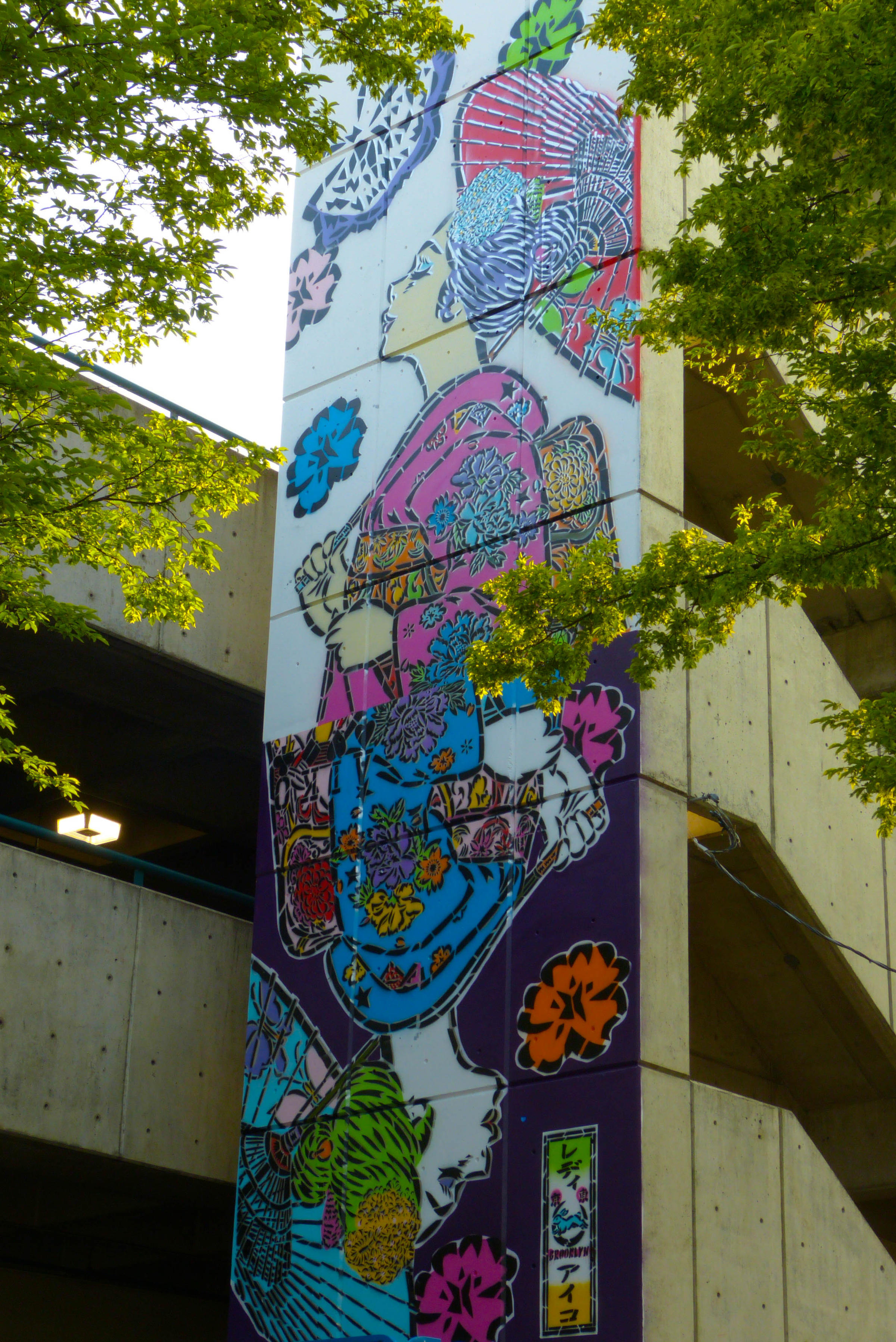 mural by Lady Aiko painted in Eugene, Oregon of a Makio with playing card and butterfly motifs