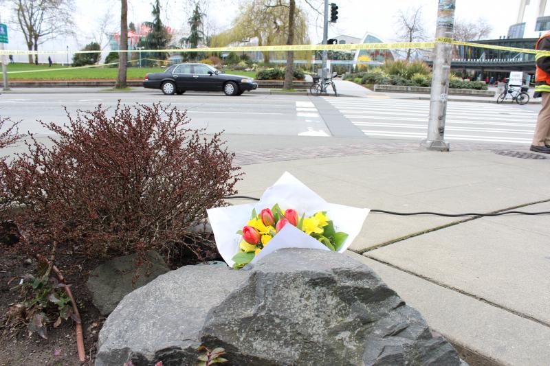 Bouquet of flowers rests across the street from the helicopter crash site on Tuesday.