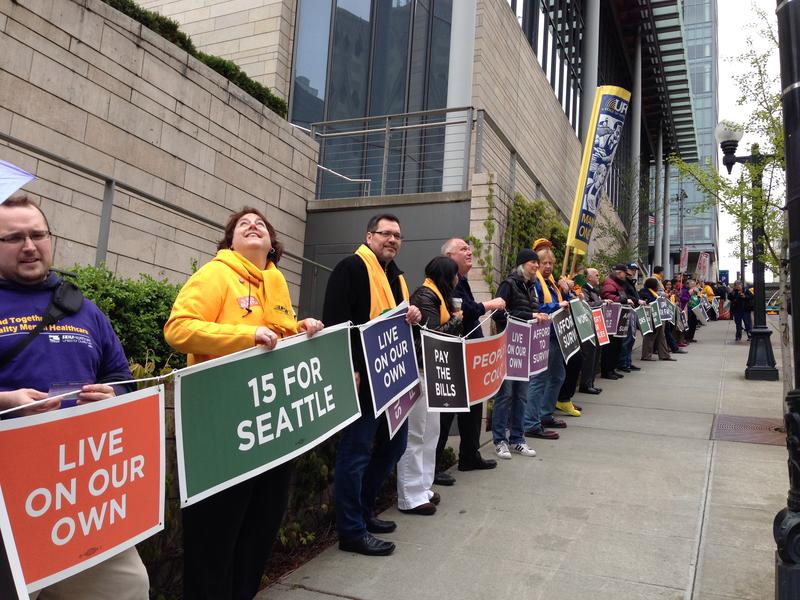 Demonstrators in Seattle form a human chain around City Hall in support of a $15 minimum wage in April 2014.