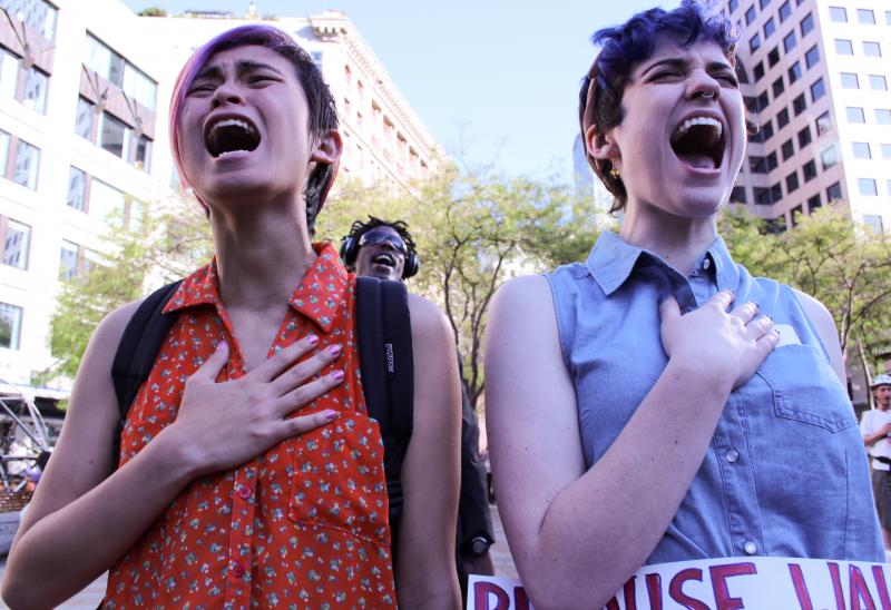 Katie Kuffel, right, debated whether to tell her story at a rally on Friday opposing violence against women. The rally stemmed from the May 23 shootings in Santa Barbara the week before. Kuffel's partner, Gerri DeSouza, joined her in a six-second scream.