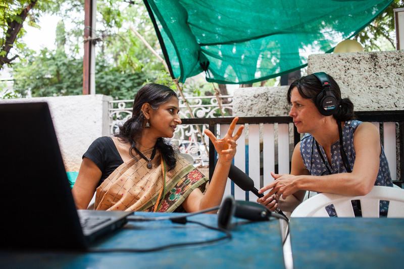 KUOW reporter Liz Jones conducting an interview in a farmers market in Hyderabad, India. 