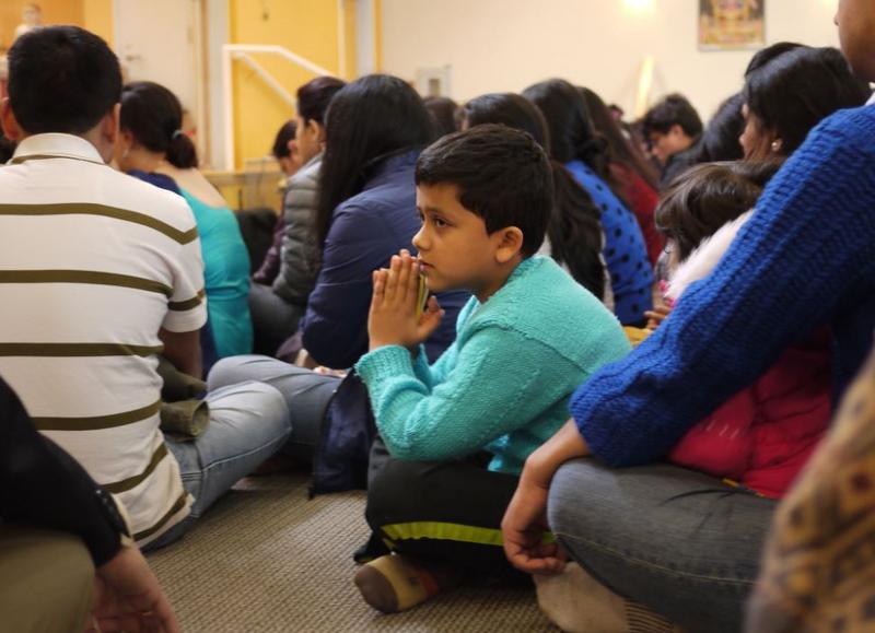 Akshar Koirala, 7, of Renton, prays with the Nepali community in Bothell following the 7.8-magnitude earthquake. 