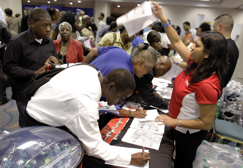 People apply for jobs at Coca-Cola at a jobs fair hosted by the Congressional Black Caucus in Miami, Tuesday, Aug. 23, 2011.