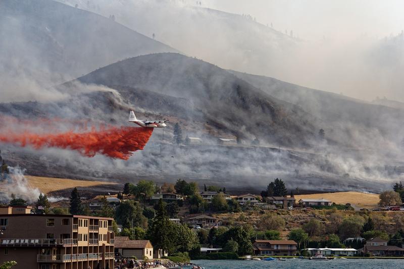 A DC-10 flies over Chelan within hours of a wildfire starting on Aug. 14. Sunbathers on holiday watched as the fire effort took hold. 