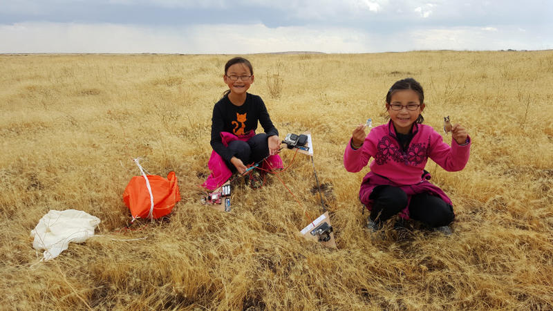 Rebecca Yeung (left), and Kimberly Yeung retrieve the Loki Lego Launcher outside Ritzville, WA, after the ballooncraft returned from the stratosphere.