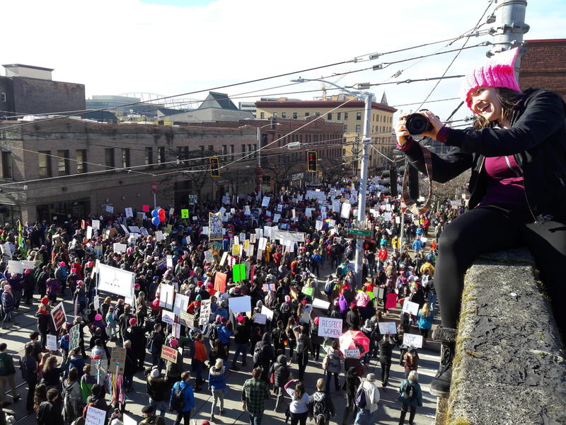 Elle Christensen watches the crowd for Seattle's women's march past her perch at Seventh and Jackson on Jan. 21.