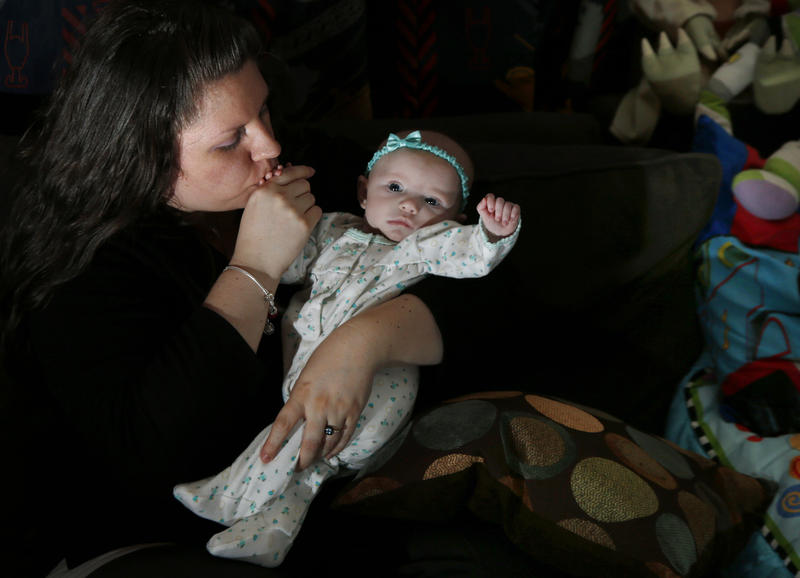 Jennifer Fontaine kisses her daughter Morgan in Methuen, Massachusetts on Tuesday, Feb. 25, 2014. After Fontaine's standard prenatal screening suggested her fetus might have Edwards syndrome, a doctor suggested a fetal DNA test, which said she was fine.