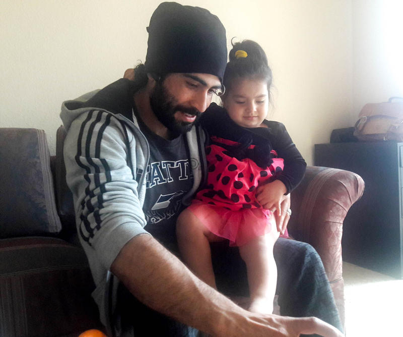 Marwal Frotan plays with his daughter Bushra in their Kent home. Frotan and his family moved to Seattle four months ago.
