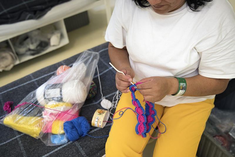An immigrant detainee knits at the Northwest Detention Center in Tacoma. 