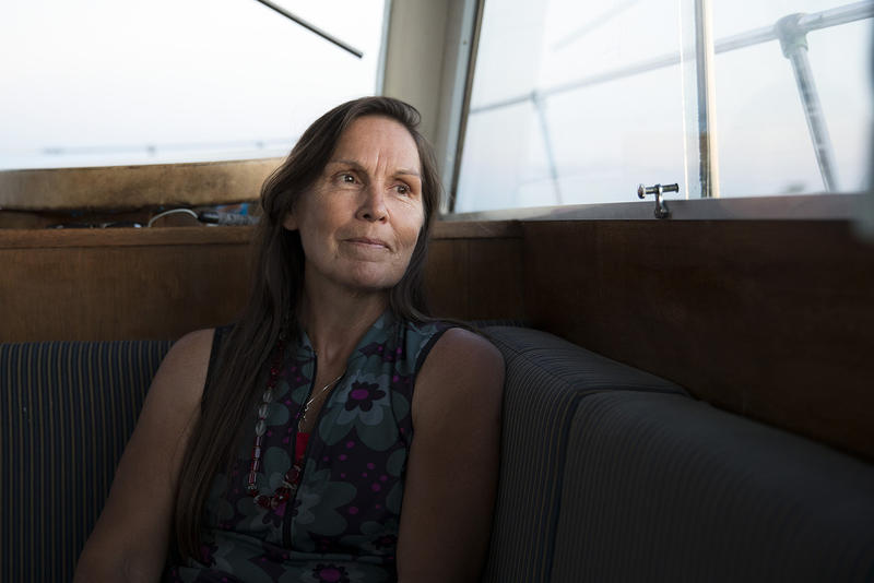 Deborah Alexander, one of the many people who were tribally disenrolled from the Nooksack tribe, looks out of the window of a safety boat during the first leg of a canoe journey on Thursday, July 27, 2017, in Point Roberts.