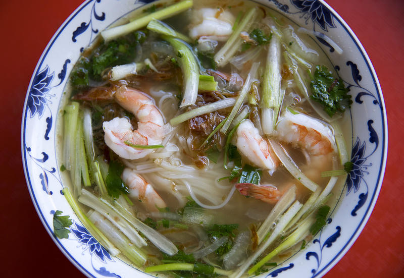 Pho with cilantro, onion, green onion, prawns, noodles, fried shallots and beef broth is shown on Tuesday, August 15, 2017, at Pho Bac on S. Jackson St., in Seattle. 