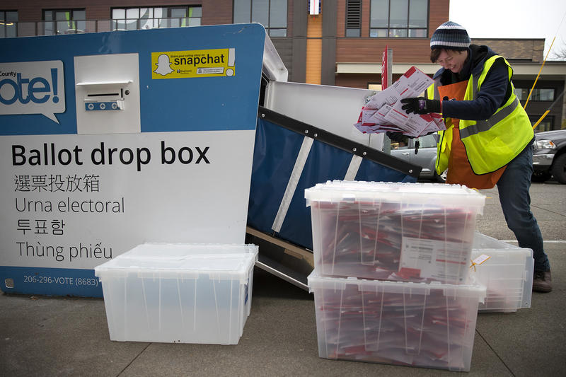 FILE: King County Elections employee Josephine Ruff unloads a  full ballot drop box outside of the Seattle Public Library in Ballard in November of 2017.