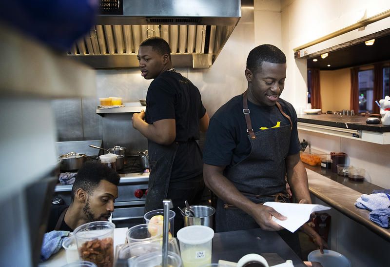 Edouardo Jordan, right, works in the kitchen at JuneBaby on Wednesday December 6, 2017, in Seattle. 