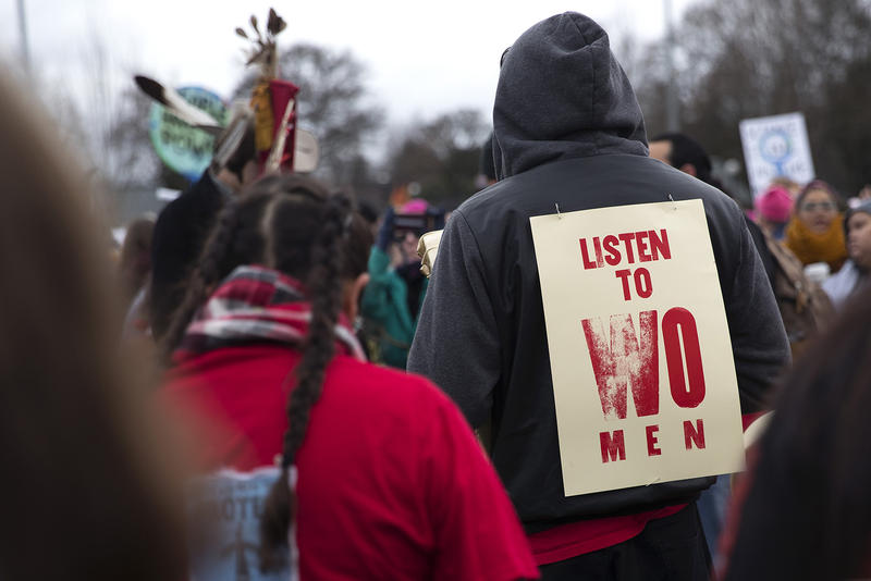A crowd gathers to listen as members of the Missing and Murdered Indigenous Women of Washington group speak during a rally before the Women's March at Cal Anderson Park on Saturday, January 20, 2018, in Seattle.