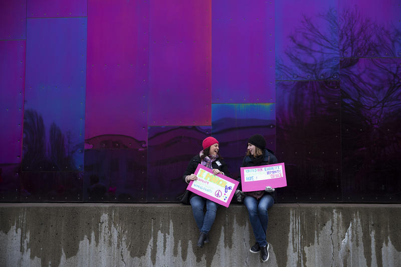 Jordana Miller and Kerry Rivers sit outside of the Museum of Pop Culture after the Women's March on Saturday, January 20, 2018, at Seattle Center.