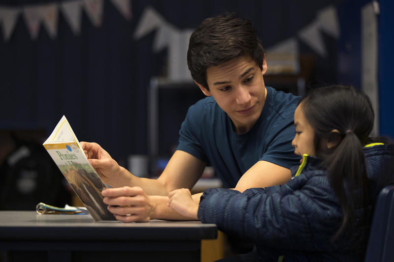 Volunteer Anthony Lee reads with Elizabeth Riff on Wednesday, January 24, 2018, at Sanislo Elementary School in West Seattle. 