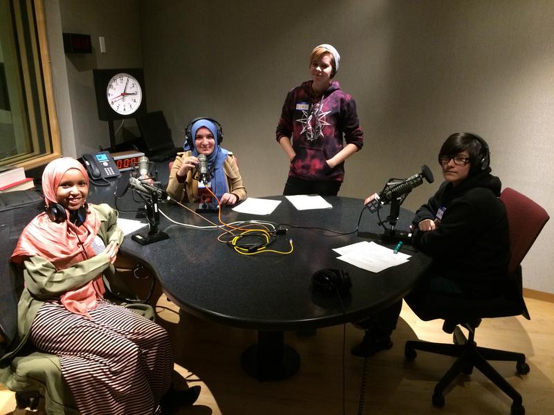 Coalition for Refugees from Burma participants Asiya Jeylani, Rafal Sultan, and Halli Cruz record their script in KUOW's studios.