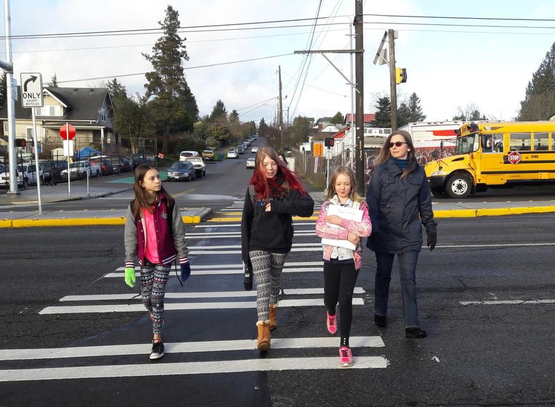 Angel Hackman leads Ruby Oswell (center left) and her friends across Aurora's new crosswalk at 92nd on their way to school.