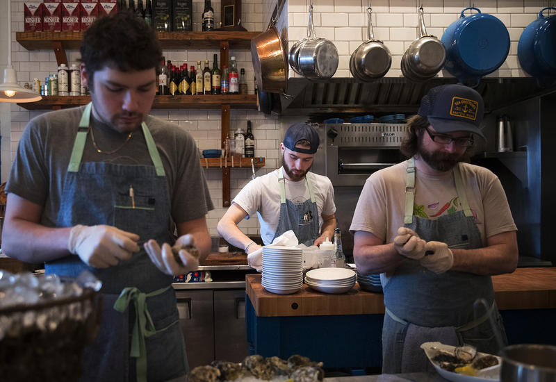 From left, Damian Bogas, Evan Potter and Keegan Obrien work on Sunday, March 4, 2018, at the Walrus and the Carpenter in Seattle. 
