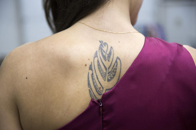 Taylor Johnson's tattoo of a Monstera leaf, a trademark of the Ke'ala 'O Kamailelauli'ili'i halau, is visible on Thursday, March 22, 2018, while practicing their 'Auana dance at the halau in Federal Way.