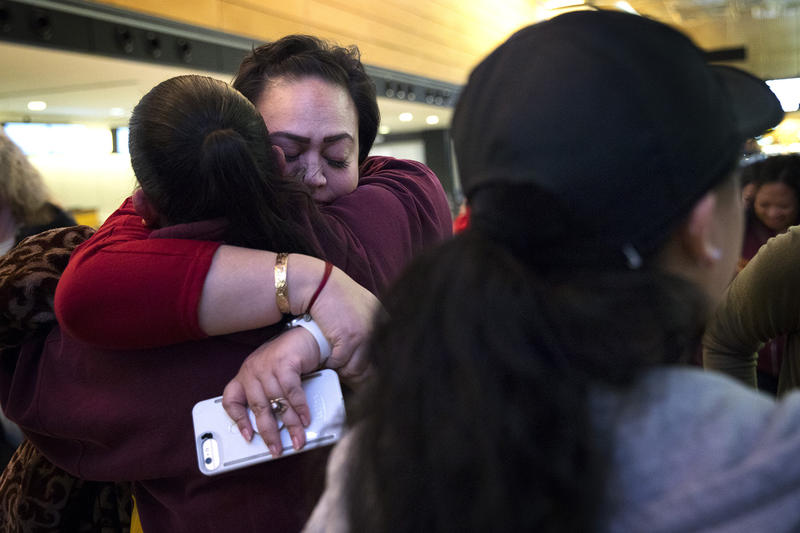 Tanya Jose, center, hugs Lynn Whalen on Friday, March 30, 2018, before the group leaves for the Merrie Monarch Festival in Hilo, at Seattle-Tacoma International Airport. 