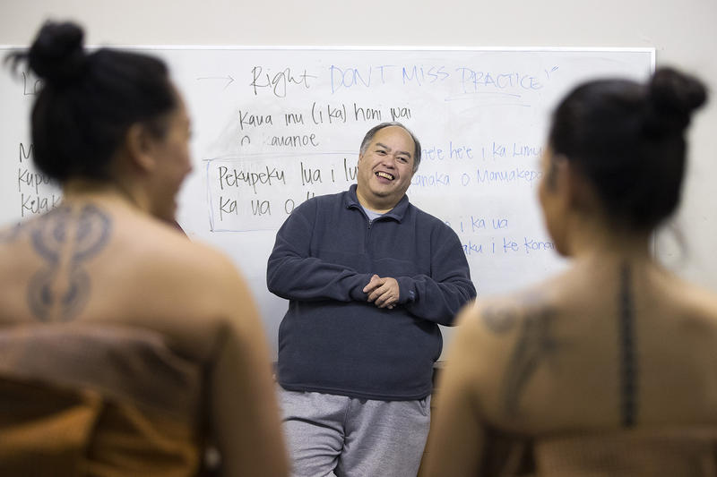 Kumu Hula Kamaile Hamada, center, laughs as he checks to make sure the lengths of all of the dancer's Kahiko dresses match on Thursday, March 22, 2018, at the halau in Federal Way. 