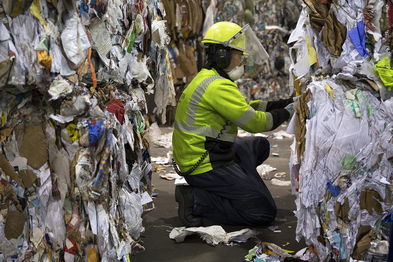 Recology employee Zakarya Sales works at the final quality control station, removing any visibly obvious contaminants from sorted bales, at the Recology Materials Recovery Facility on Tuesday, October 31, 2017, on S. Idaho St., in Seattle. 
