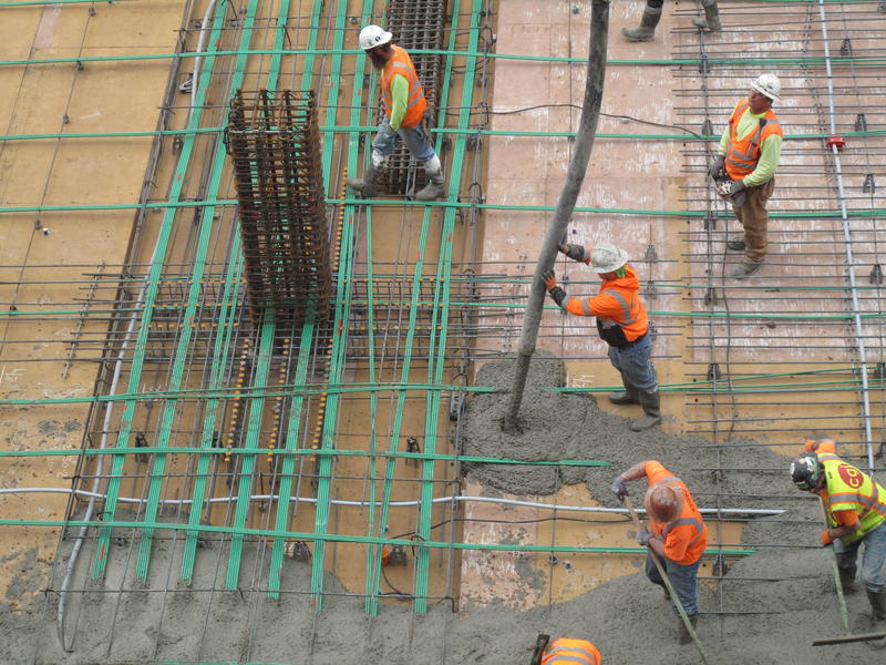 Workers pour concrete for a floor of an office tower in Renton. Pouring concrete carries a lot of risk for workers. 